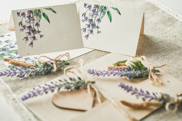 Fototapeta na wymiar cards for lettering names blank, envelope on table with lavender