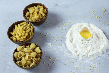ingredients for homemade pasta. Food background: macaroni, spagetti, egg, flour