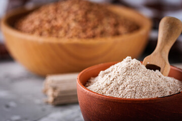 fresh natural buckwheat flour on a dark stone background culinary concept