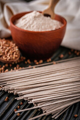 fresh natural buckwheat flour on a dark wooden rustic background culinary concept