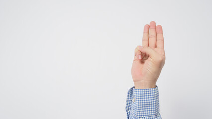 Male wear long sleeve shirt is doing a hand sign of 3 fingers point up meaning three, third or use in protest.It put on white backgroud