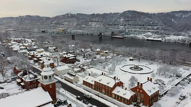 A snowy aerial view of a small Pennsylvania river town. A bridge over the Ohio River in the distance. Pittsburgh suburbs. Summer version available.  	