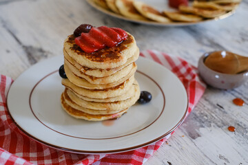 Delicious pancakes with blueberry and strawberry