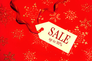Naklejka na ściany i meble Label with the text - sale, with a discount, on a decorated Christmas background, during the Christmas and New Year holidays.