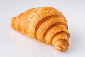 delicious fresh croissant on a white acrylic background