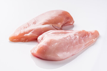 raw chicken fillet on a white acrylic background