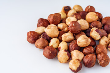 fresh natural hazelnuts on a white acrylic background