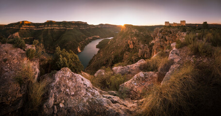 Sunset at Chirel Castle Cortes de Pallás, Spain. Nice sunset, seeing the lake and the sun setting behind the mountains. Landscape on top of a mountain with a medieval castle