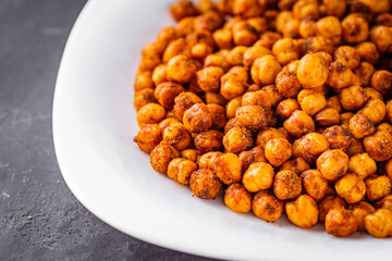 fried chickpeas on a dark stone background