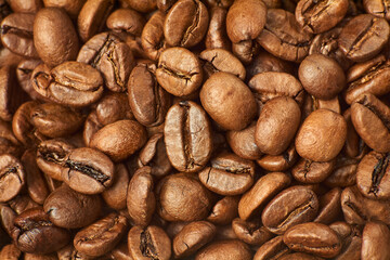 Roasted coffee beans close up background