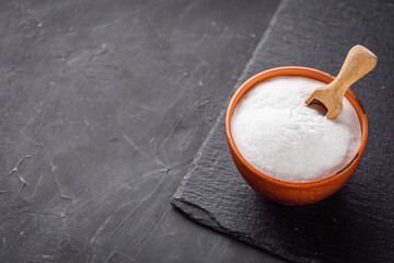 baking soda powder on a dark stone background