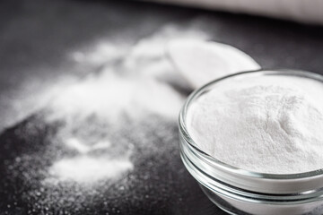 baking soda powder on a dark stone background