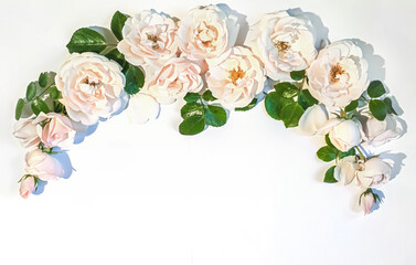 Flowers composition. Rose flowers on white background. Flat lay, top view, copy space. Background for Valentine's Day card. Border frame.