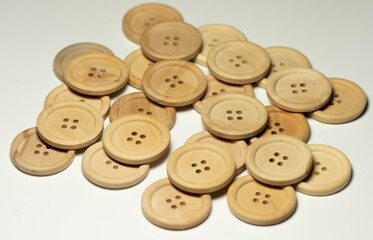 Obraz premium Natural round wooden sewing buttons isolated on white background. Close up. Macro.
