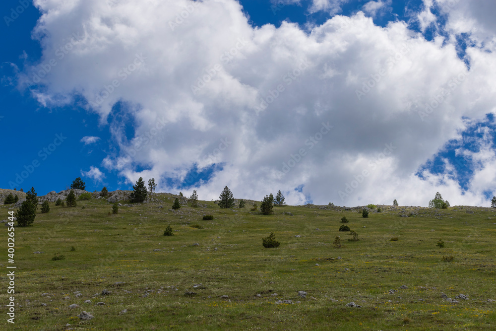 Wall mural Mountain landscape with clouds