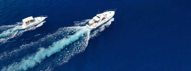Aerial drone ultra wide photo of speed boat cruising fast in deep blue Aegean Sea