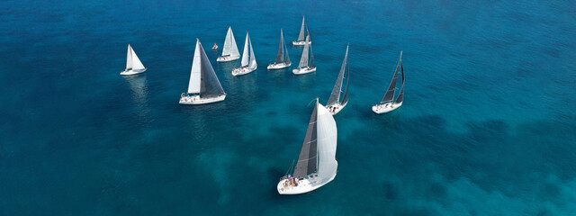 Aerial drone ultra wide photo of beautiful sail boat sailing in turquoise Ionian island sea