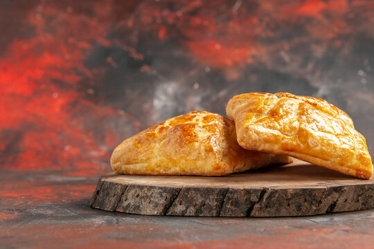 front view penovani khachapuri on wood board on dark red background free place