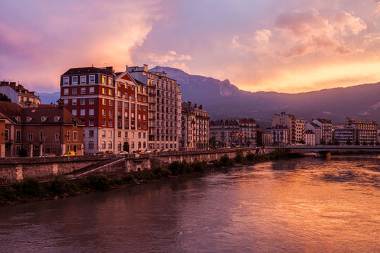 France, Auvergne-Rhone-Alpes, Grenoble, Grenoble architecture along Isere River seen at sunset