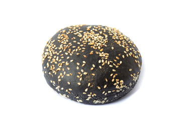 Homemade bun for black burgers with sesame isolated on white background