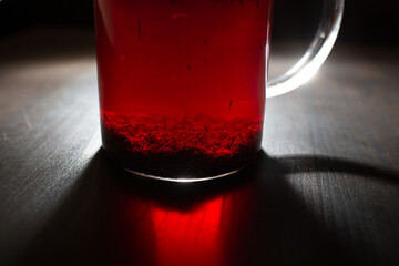 Glass cup of rooibos tea on wooden table