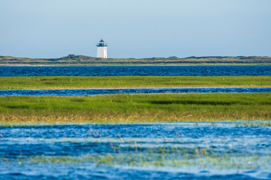 USA, Massachusetts, Cape Cod, Provincetown, Bay of water with lighthouse
