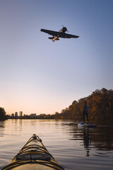 Passing the airport while paddling on the Tennessee River in Knoxville at Sunset  - obrazy, fototapety, plakaty