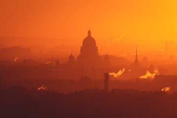 Naklejka premium Aerial panoramic view of Saint-Petersburg, Russia, with St. Isaac's cathedral, the Winter Palace and Admiralty, with beautiful vibrant red orange sunset sundown, dusk cityscape silhouette scenery