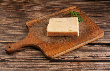 Plain raclette cheese on a cutting board