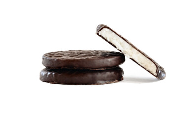 Stack of dark chocolate covered candies with a creamy peppermint filling and missing bite. Isolated over a white background with clipping path included.