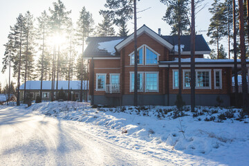 A view of cozy wooden scandinavian cabin cottage chalet house covered in snow near ski resort in...