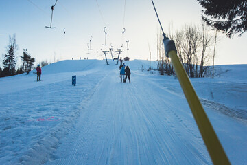 Beautiful cold mountain view of ski resort, sunny winter day with slope, piste and ski lift, with...