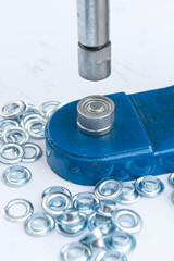 Close up hand press eyelet machine and eyelets details © ozencdeniz