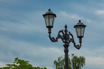 Vintage street lamp on blue sky background