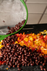Corn, black beans and bell peppers being prepared for a meal.