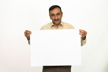 Man holding billboard in his hand. The man is dressed in a white shirt and fabric pants. Isolated image on white background.