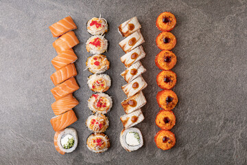 set of sushi lying on shiny stone surface