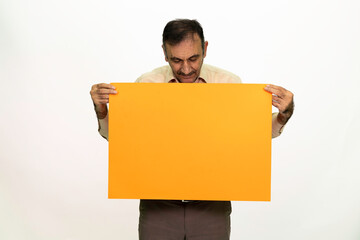 Man holding billboard in his hand. The man is dressed in a white shirt and fabric pants. Isolated image on white background.