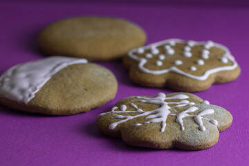 Baking and decorating homemade Christmas gingerbread cookies. Colorful background. 