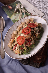 Salad in an oblong dish on the table. Vintage. Retro. Old letters, beads, bought in the early 70s 