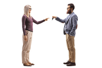 Bearded man giving keys to a blond woman