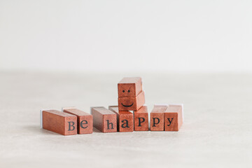 Words Be Happy made up of wooden cubes with letters. Emotions.