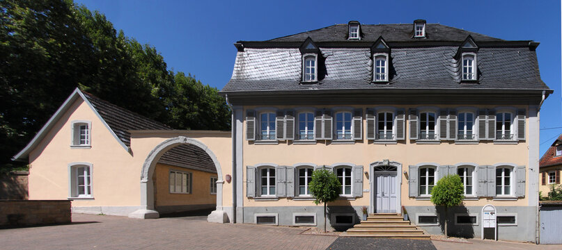 Facade of a baroque town palace with mansard roof and court gate in the old town of Meisenheim
in Germany