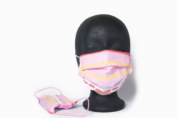 Hand made protective mask  on black styrofoam headstand