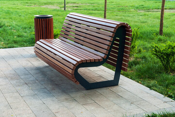 modern park bench and waste bin made of wooden planks