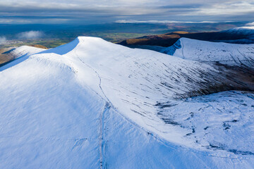 Aerial view of beautiful snow capped mountains (Pen-y-Fan, Brecon Beacons, Wales)