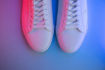 Fototapeta na wymiar Pair of sneakers on color background, top view