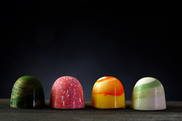 Chocolate bonbon. Luxury handmade chocolate bonbons on wooden table with night background, copy...