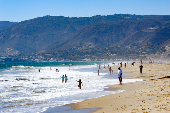 Beach goers enjoying the summer sun and surf