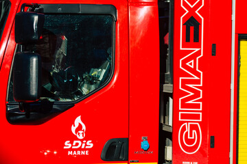 View of a red French fire engine in intervention in front of the Reims cathedral during the coronavirus pandemic affecting France and the lockdown of the country
